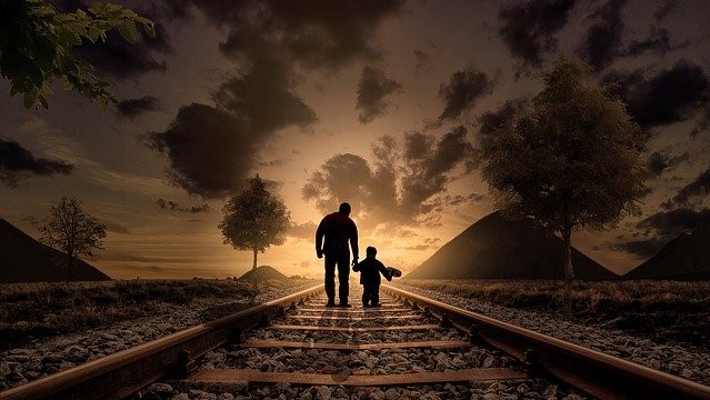 Father and Son walking down the tracks