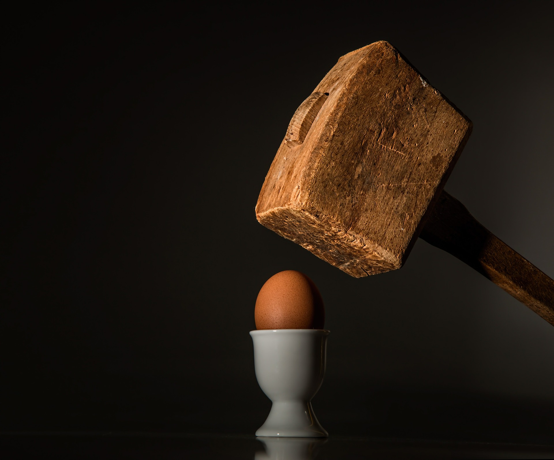 Wooden Mallet Hitting Egg