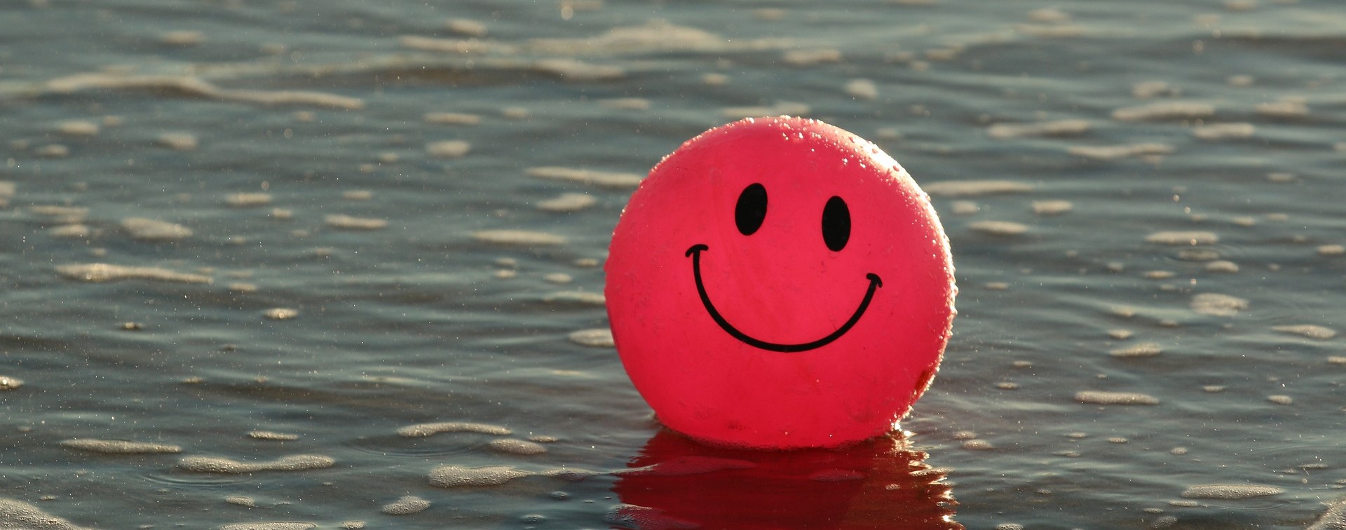 Happy Face Beach Ball on water