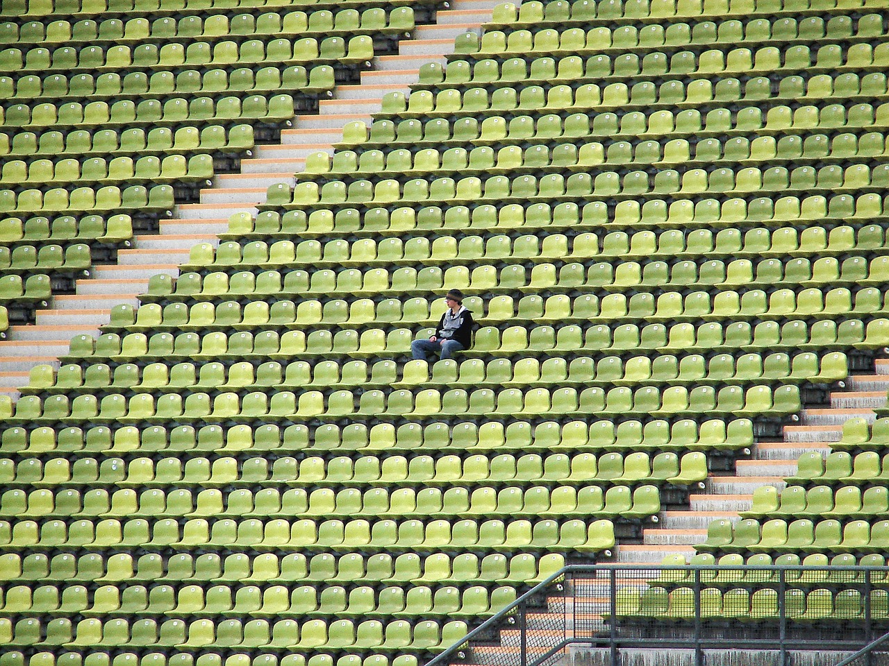 Solitary sitting in an empty stadium