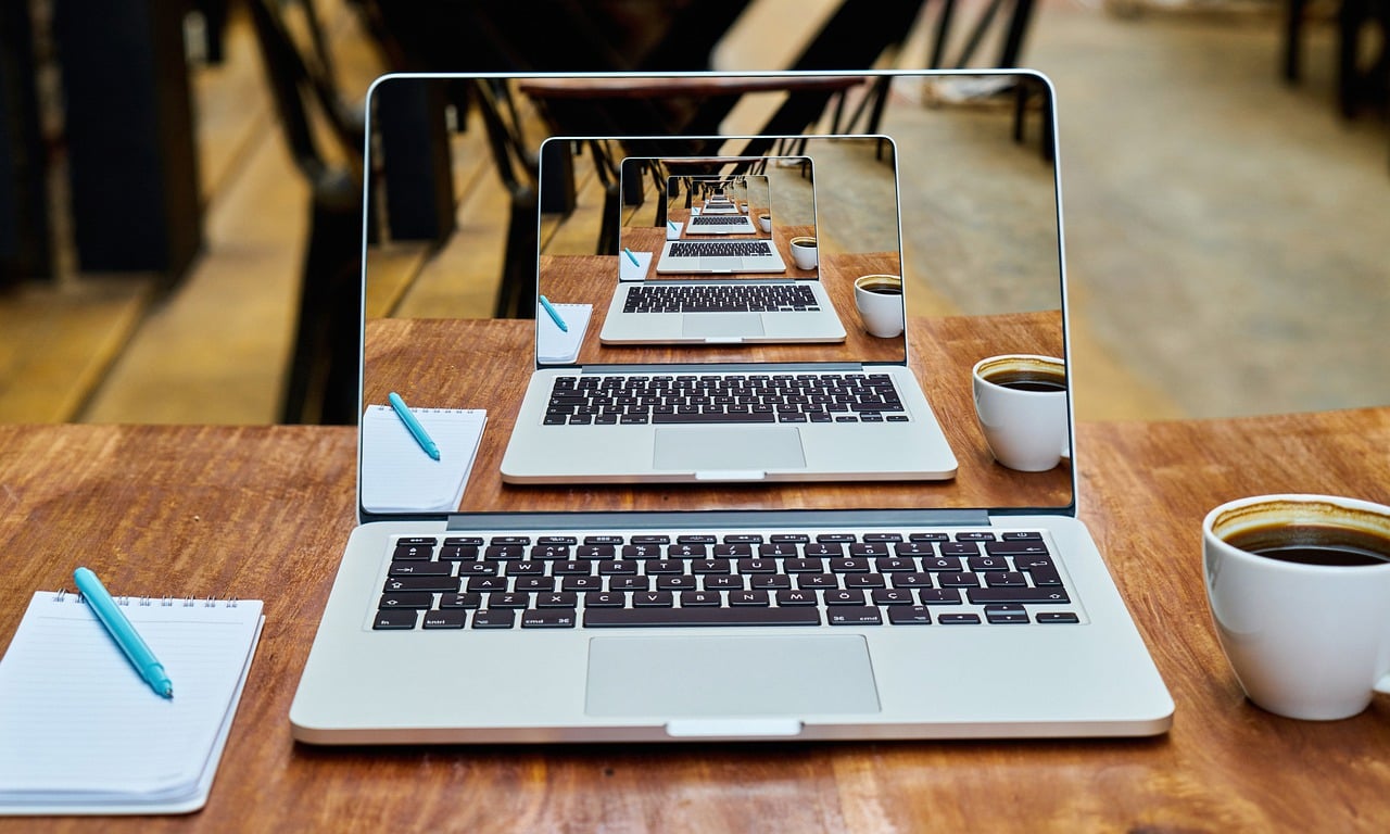 Computer screen reflecting in a mirror to show itsetf over and over