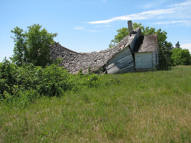 Ancient wood barn sagging and falling apart