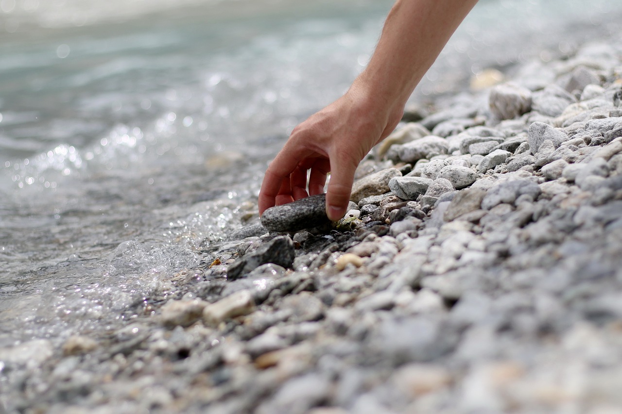 Picking up a stone at the shore