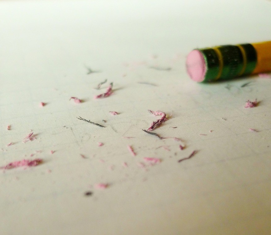 Pencil, worn eraser, and eraser dust on paper