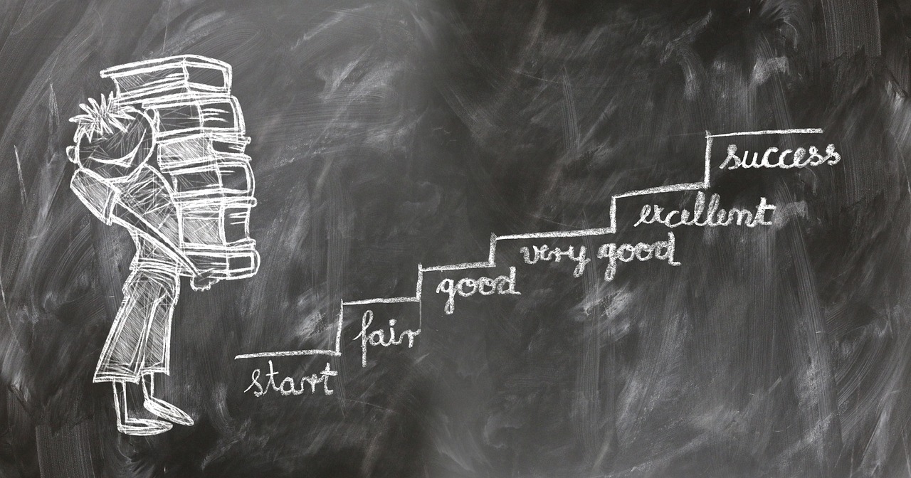 Chalk figure with load of books at bottom of stairs